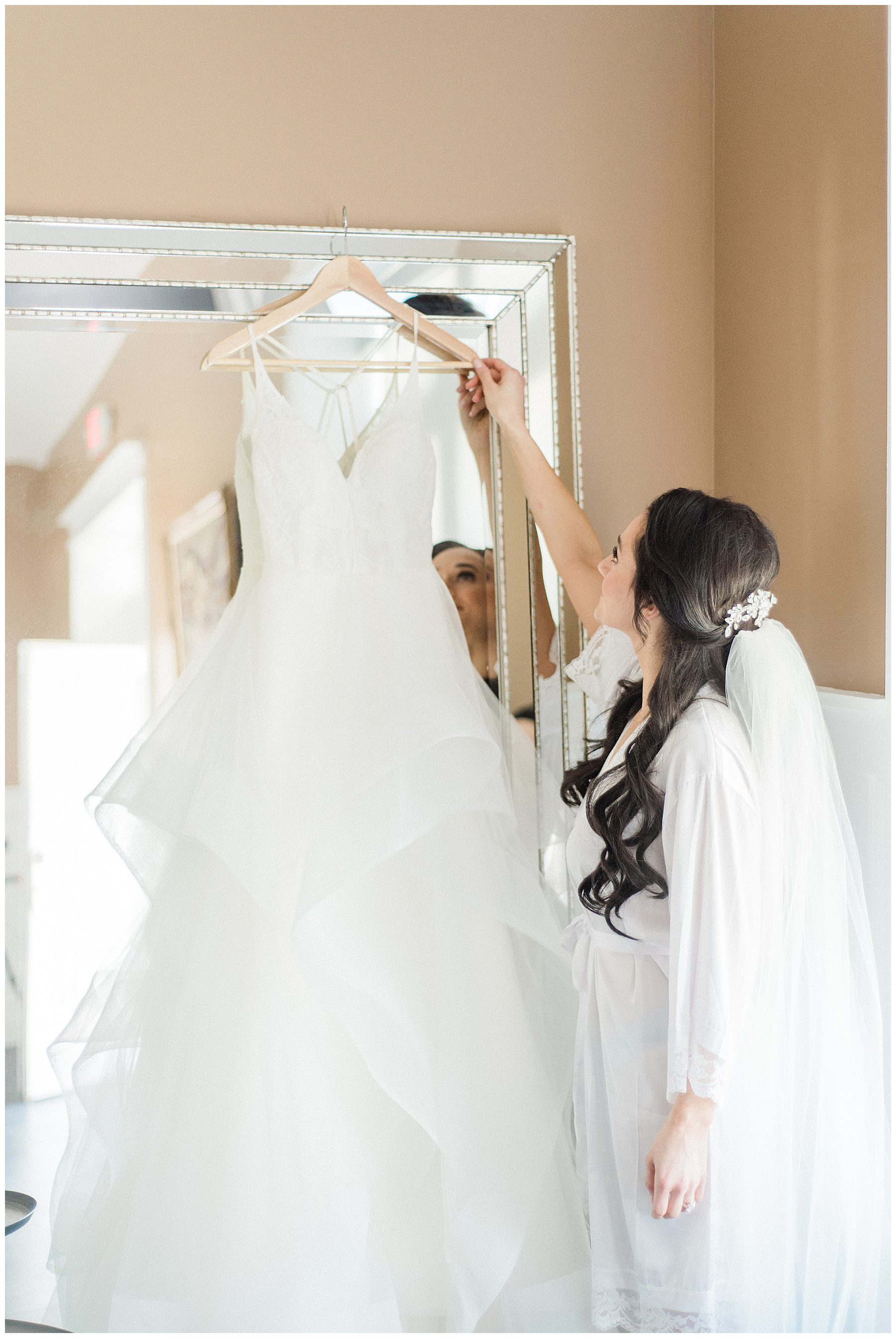 bride admiring wedding dress