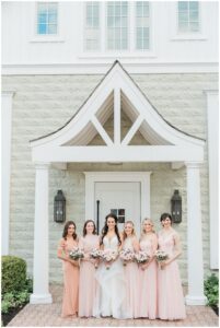 bride and bridesmaids outside of the Coach house at Ryland Inn