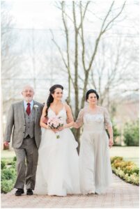 bride walks down aisle with parents