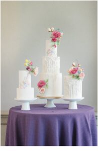 three wedding cakes on purple table cloth