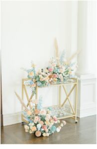 wedding flower arrangements on gold cart