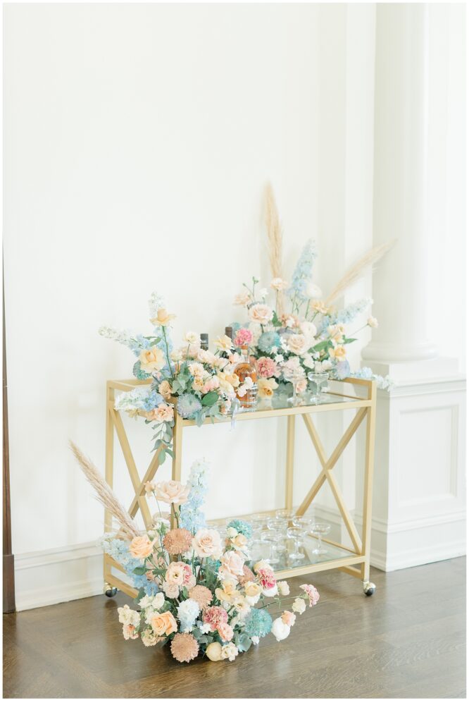 wedding flower arrangements on gold cart