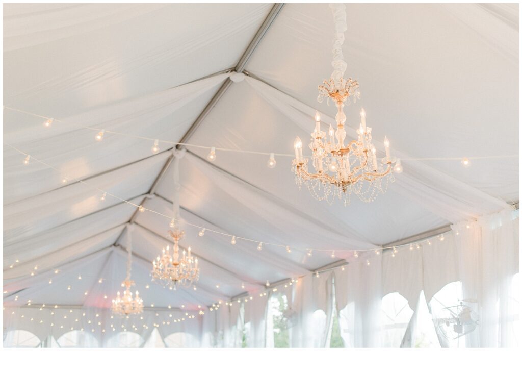 chandeliers hanging from ceiling at Late Summer Wedding at Cairnwood Estate in Bryn Athyn, Pennsylvania