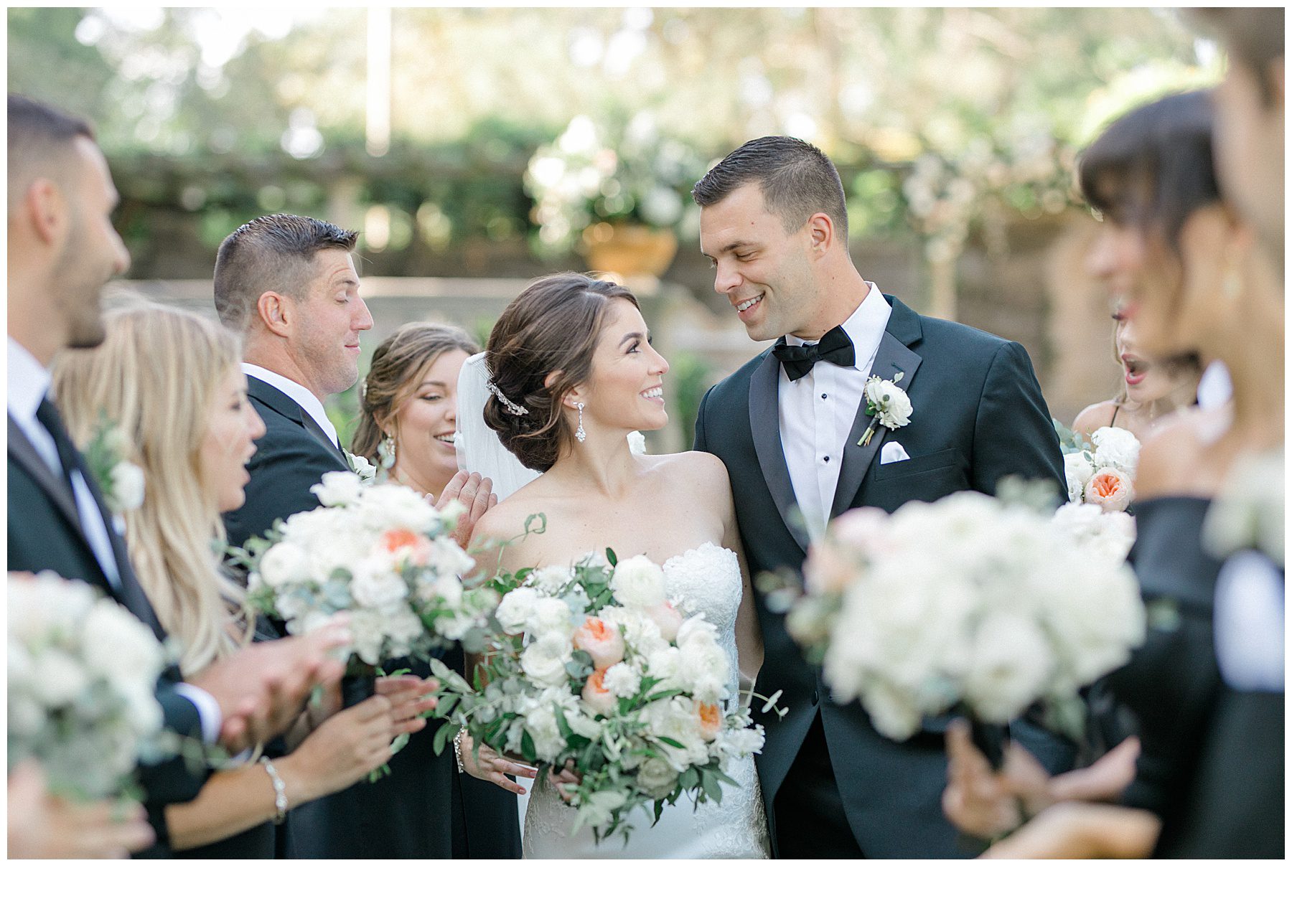 bride and groom surrounded by bridal bouquets