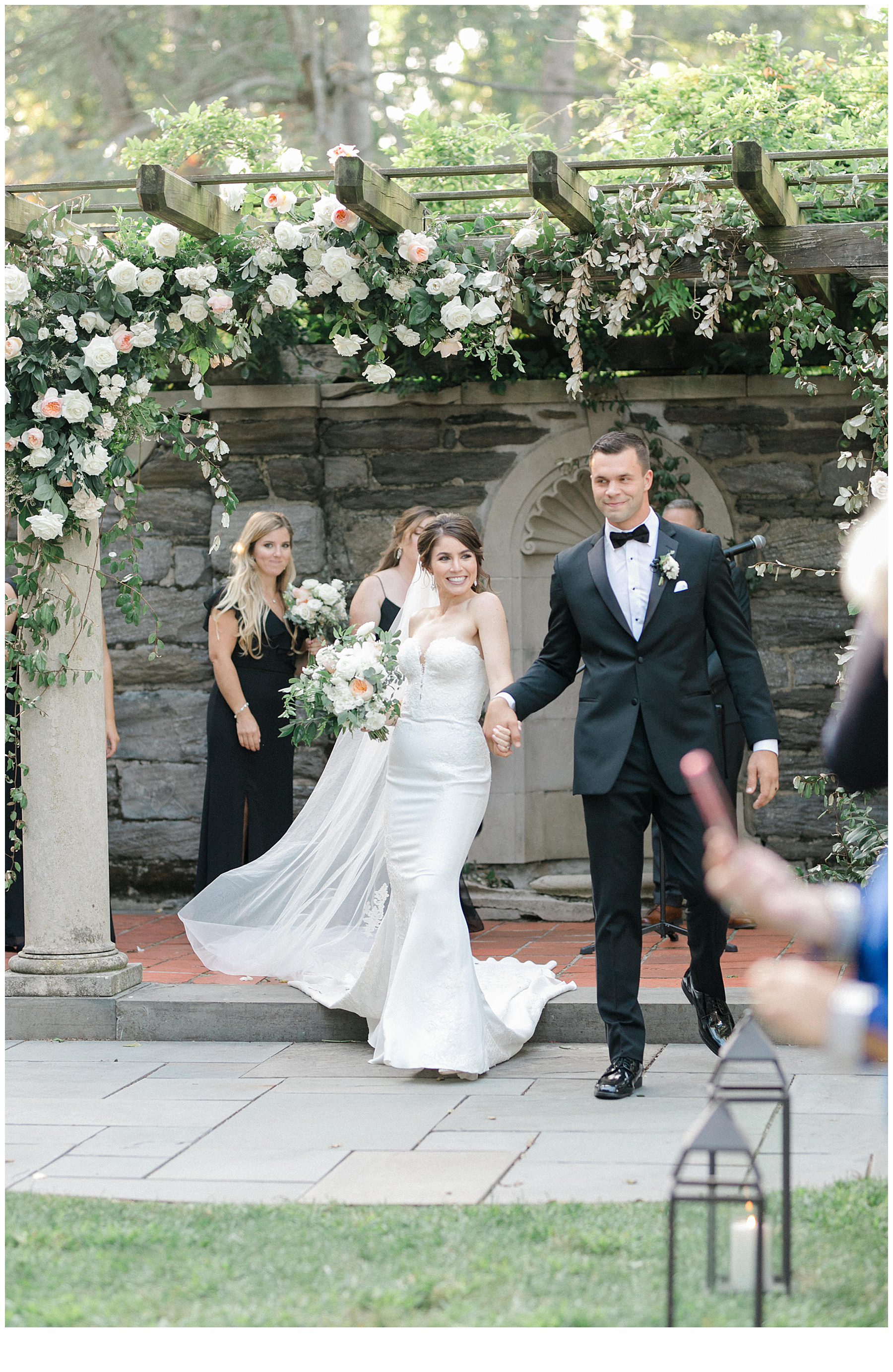 newlyweds exit wedding ceremony at Curtis Arboretum in Wyncote, Pennsylvania