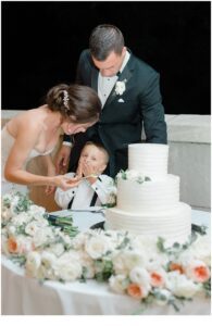bride and groom share cake with son