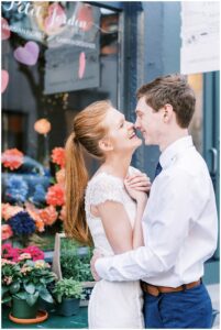 candid moment of couple outside storefront