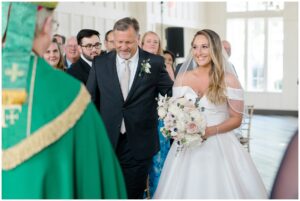 bride walks down the aisle at Ryland Inn Coach House Wedding ceremony