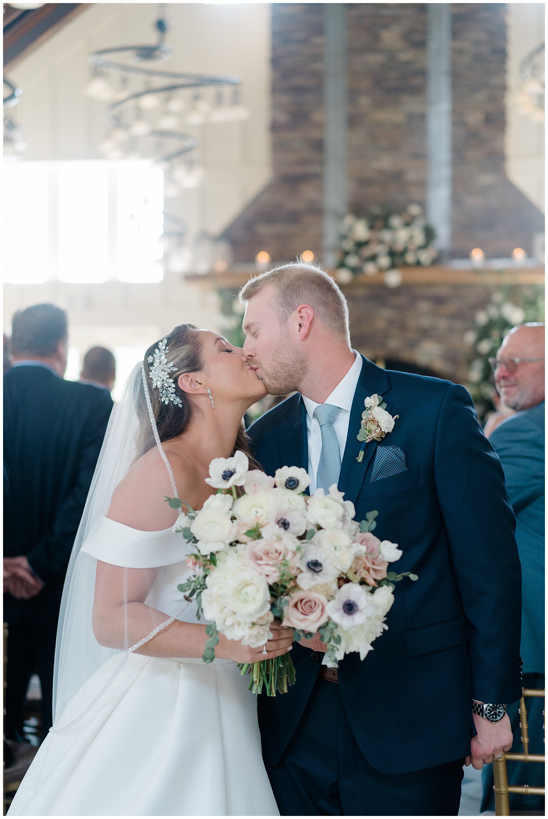 newlyweds kiss after Ryland Inn Coach House Wedding ceremony