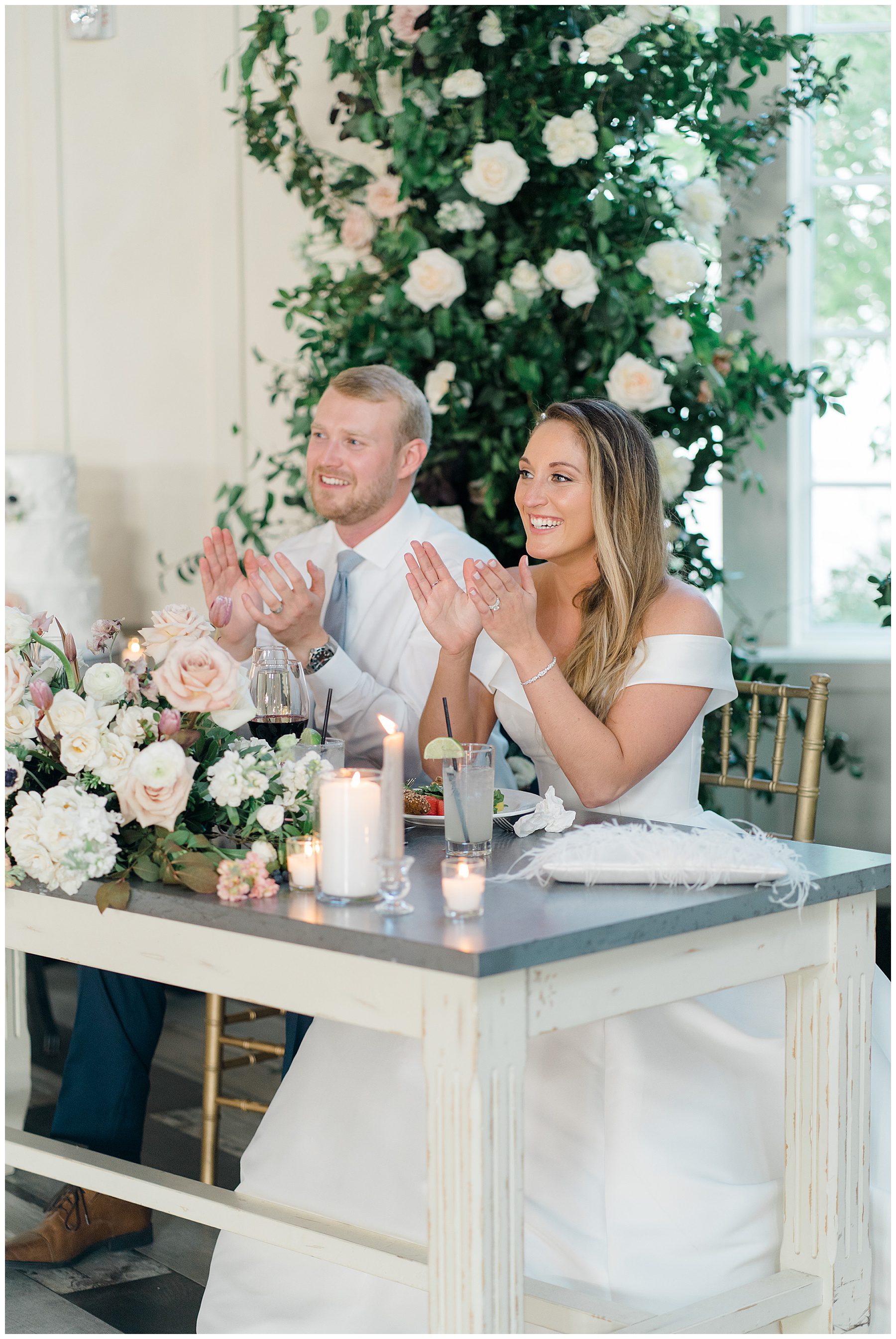 couple clapping during speeches at Ryland Inn Coach House Wedding