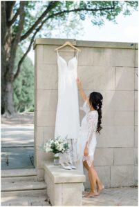 bride looks at wedding dress