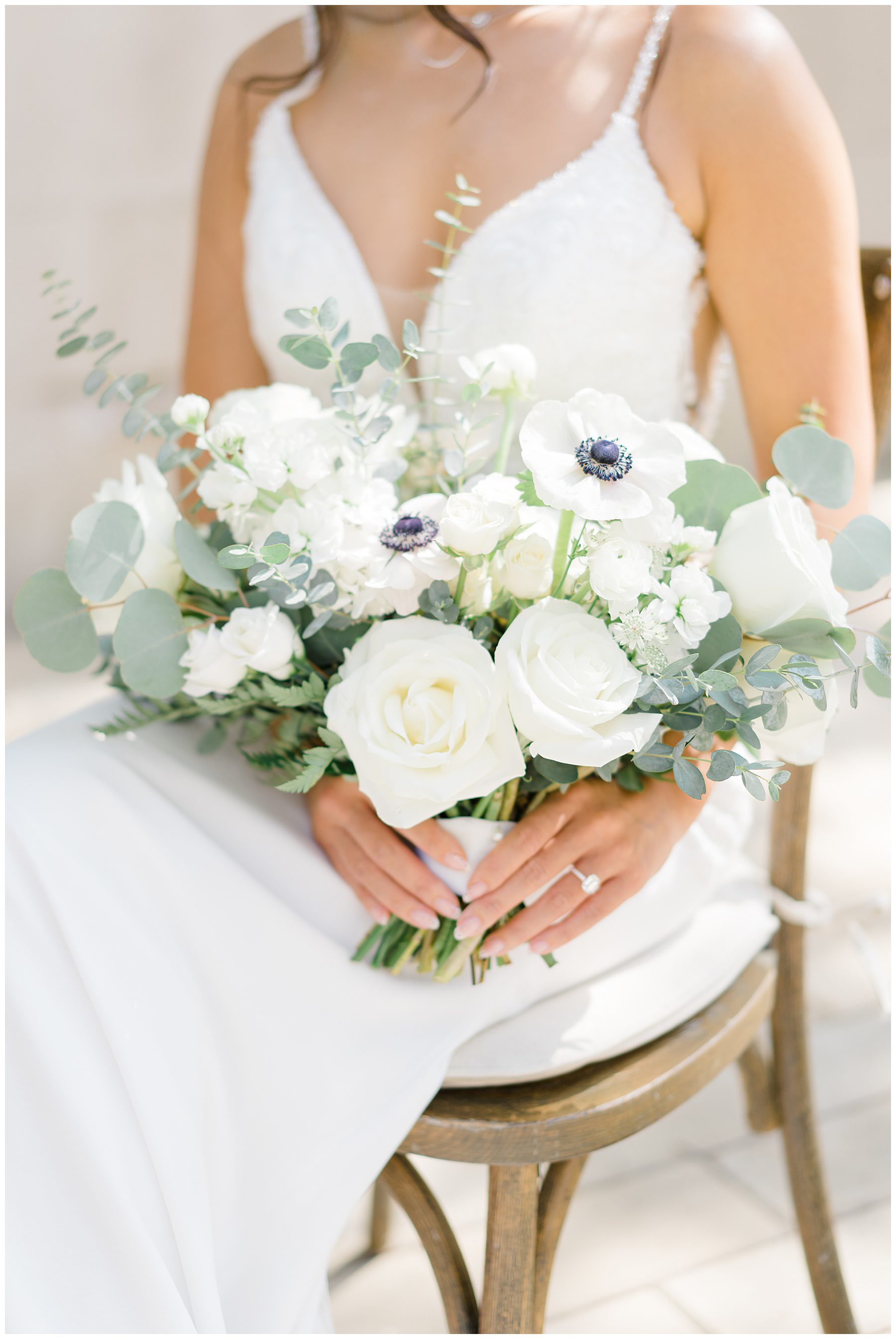 bride holding classic white wedding flowers
