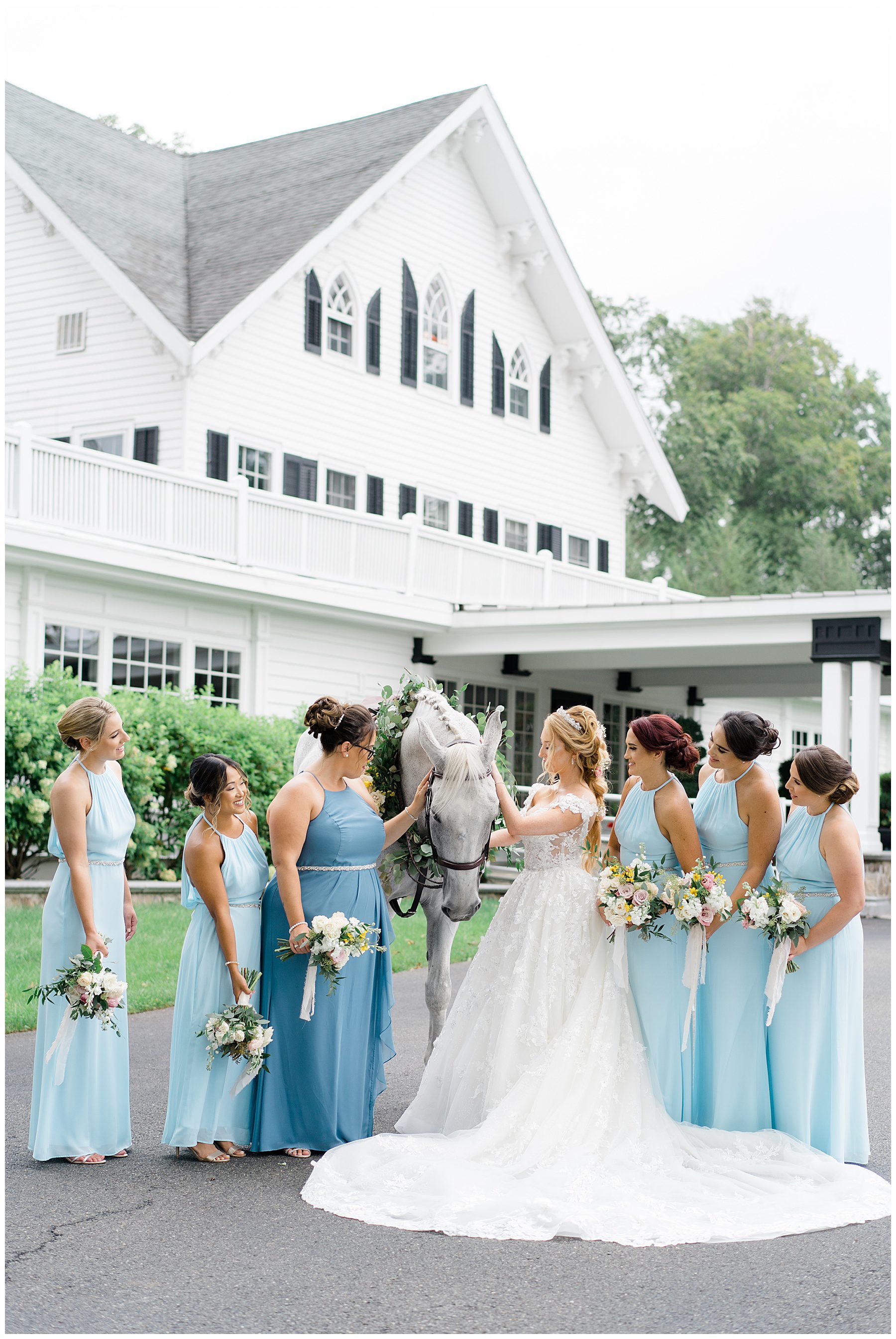 bride and bridesmaid with white horse during fairytale wedding at the Ryland Inn