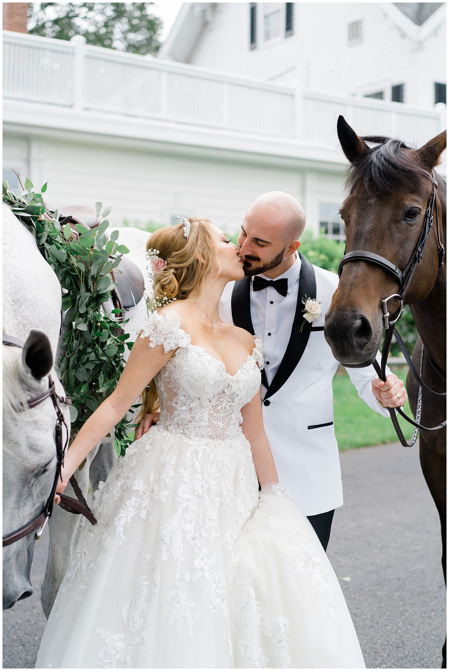 couple with horses before fairytale wedding