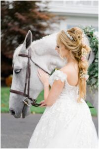 bride with white horse before fairytale wedding at Luxurious Ryland Inn Grand Ballroom