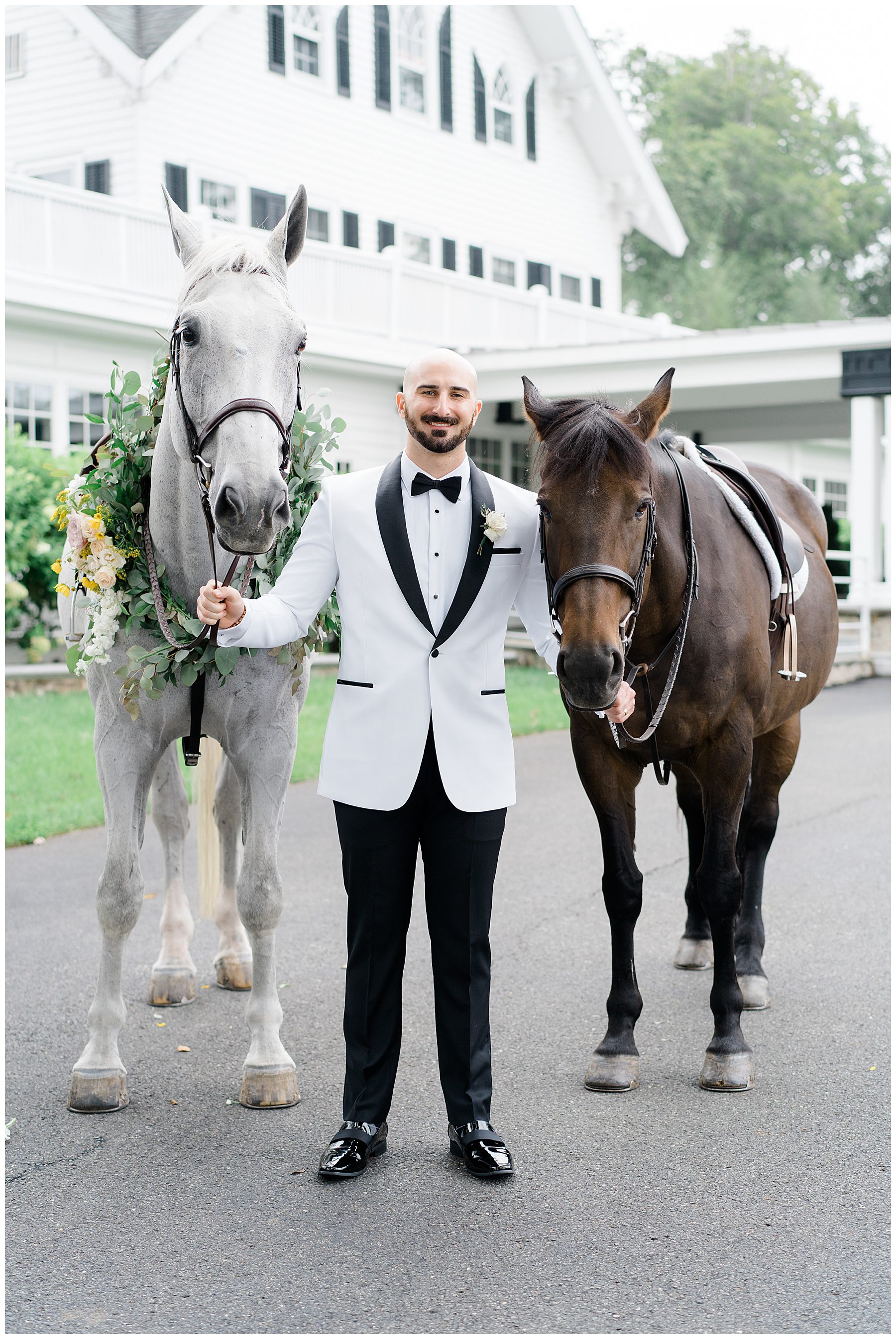 groom with horses before wedding
