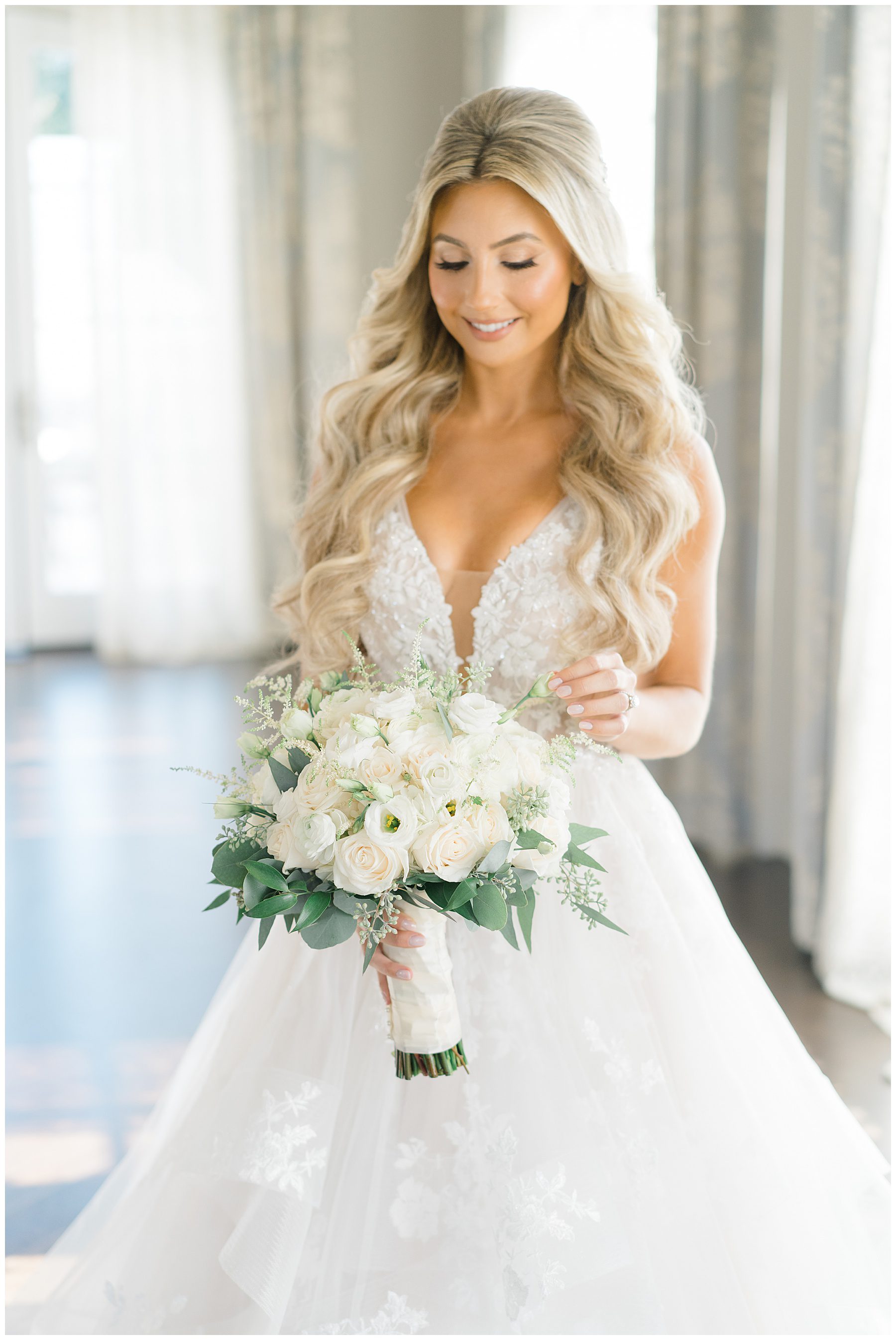 Bride touching flowers in bridal suite