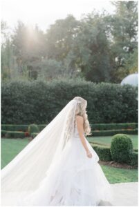 Bride walking towards groom with veil blowing in the wind