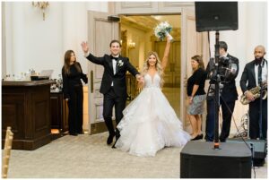 newlyweds enter Park Chateau Fall Wedding reception
