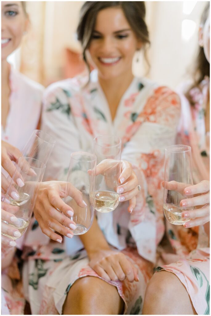 bride toasts with bridesmaids before Elegant Cairnwood Estate Wedding