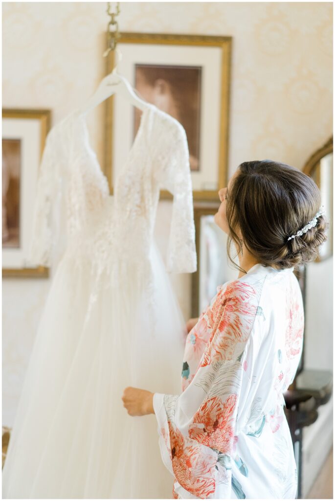 bride looks up at wedding dress