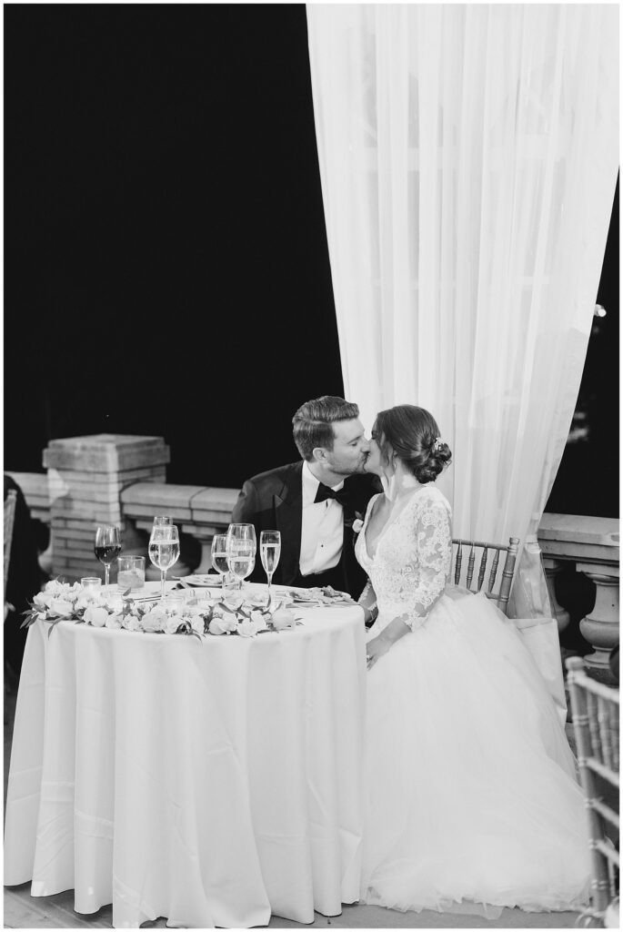 newlyweds kiss during Elegant Cairnwood Estate Wedding reception