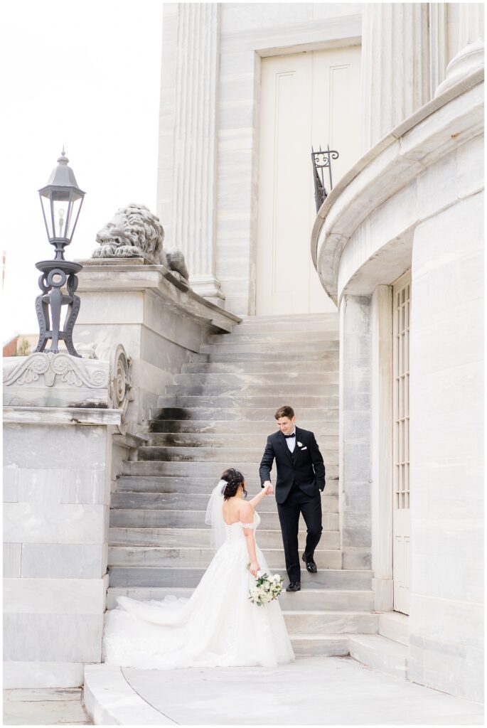 bride and groom walk up the stairs of Philadelphia wedding venue