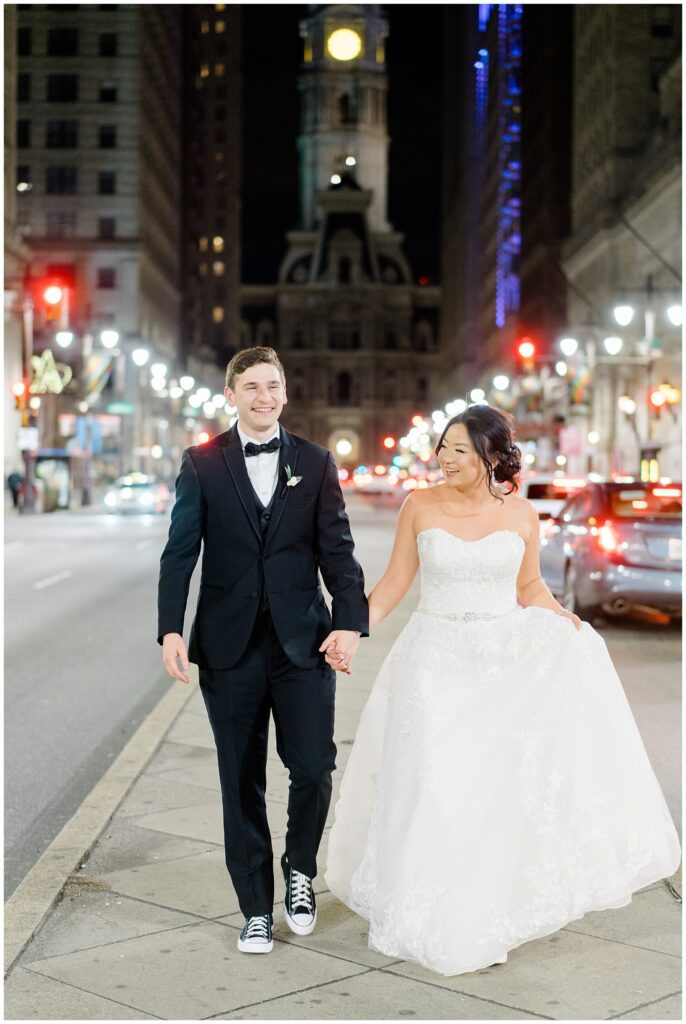 couple walk downtown after Philadelphia Winter Wedding at The Lucy