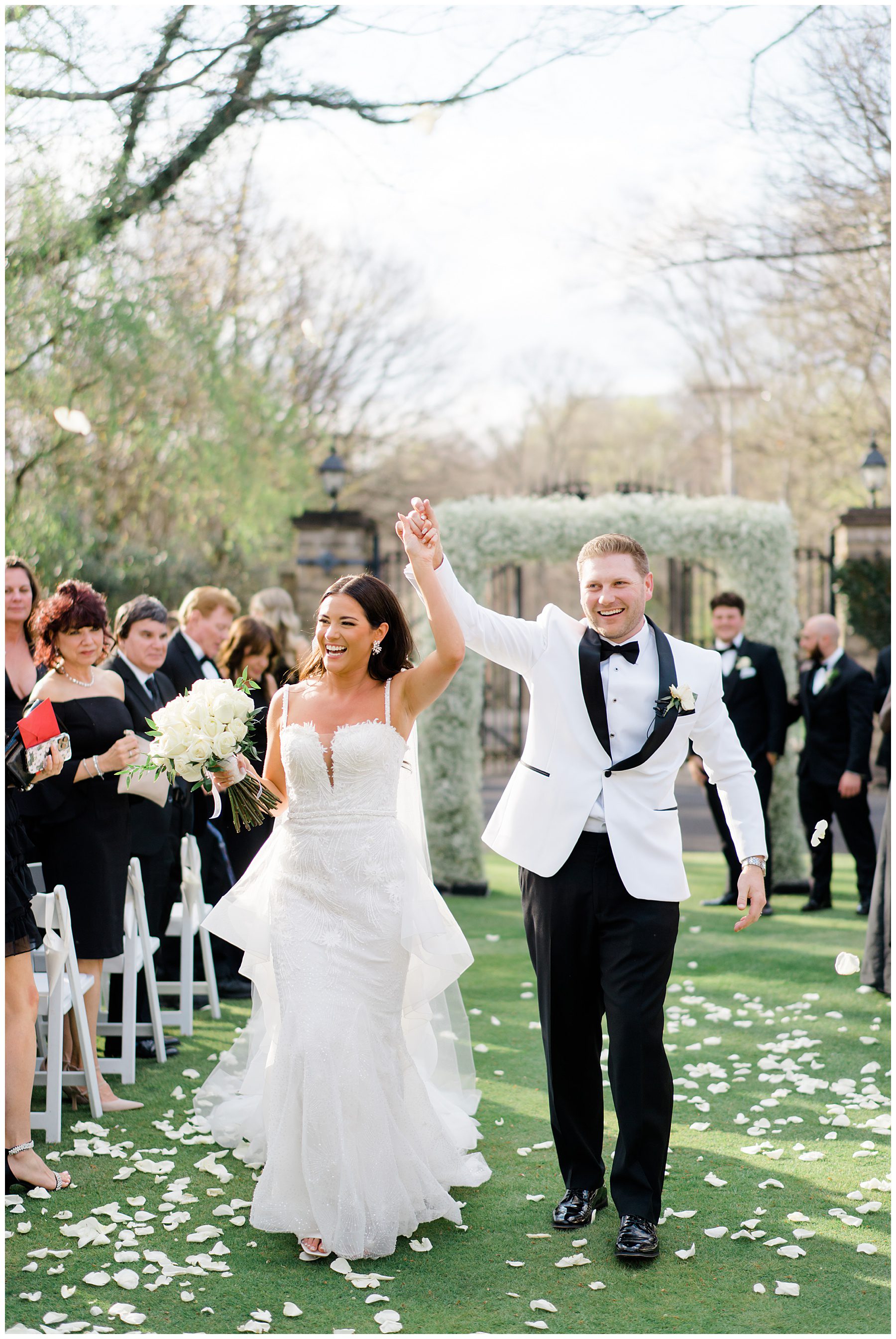 bride and groom walk down aisle together at Cairnwood Estate Wedding in Bryn Athyn, PA