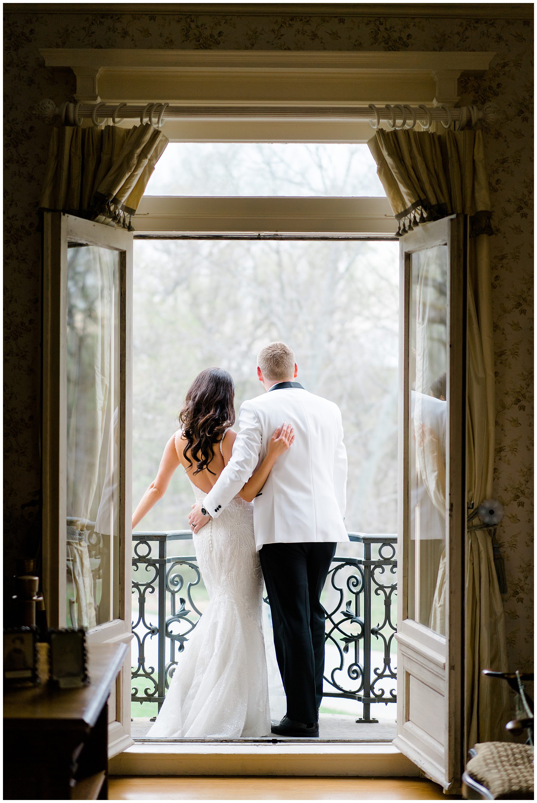 newlyweds on the balcony at Cairnwood Estate Wedding in Bryn Athyn, PA