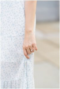 Oval diamond ring with gold band on woman's hand