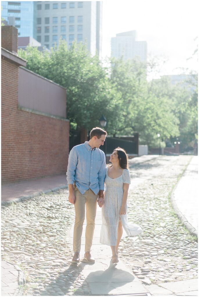 Woman and man walking together in a cobblestone street