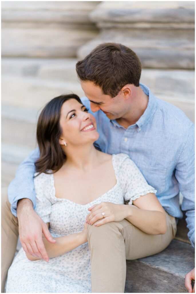Engaged woman and man sitting and smiling at one another