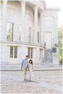 Woman and man walking away from historic building