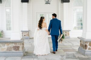 newlyweds walking around The Coach House at The Ryland Inn