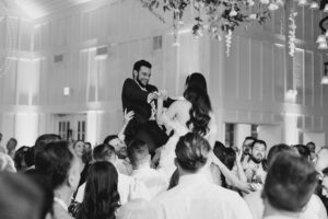 newlyweds lifted up during wedding reception tradition