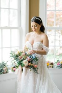 bride holding whimsical garden inspired wedding flower bouquet