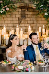 bride and groom raise their glass in a toast