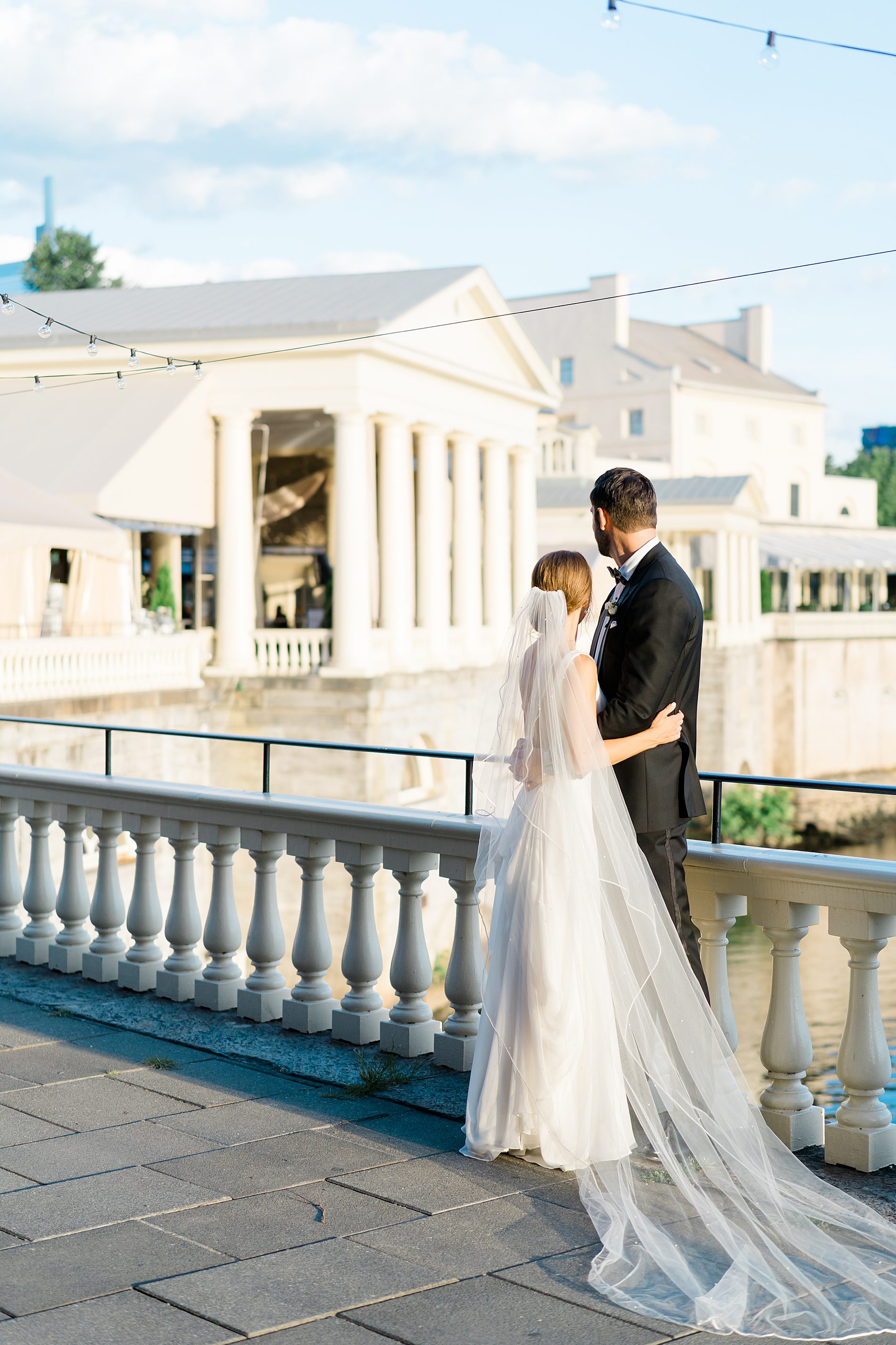 couple walking around the building at Water Works overlooking the water