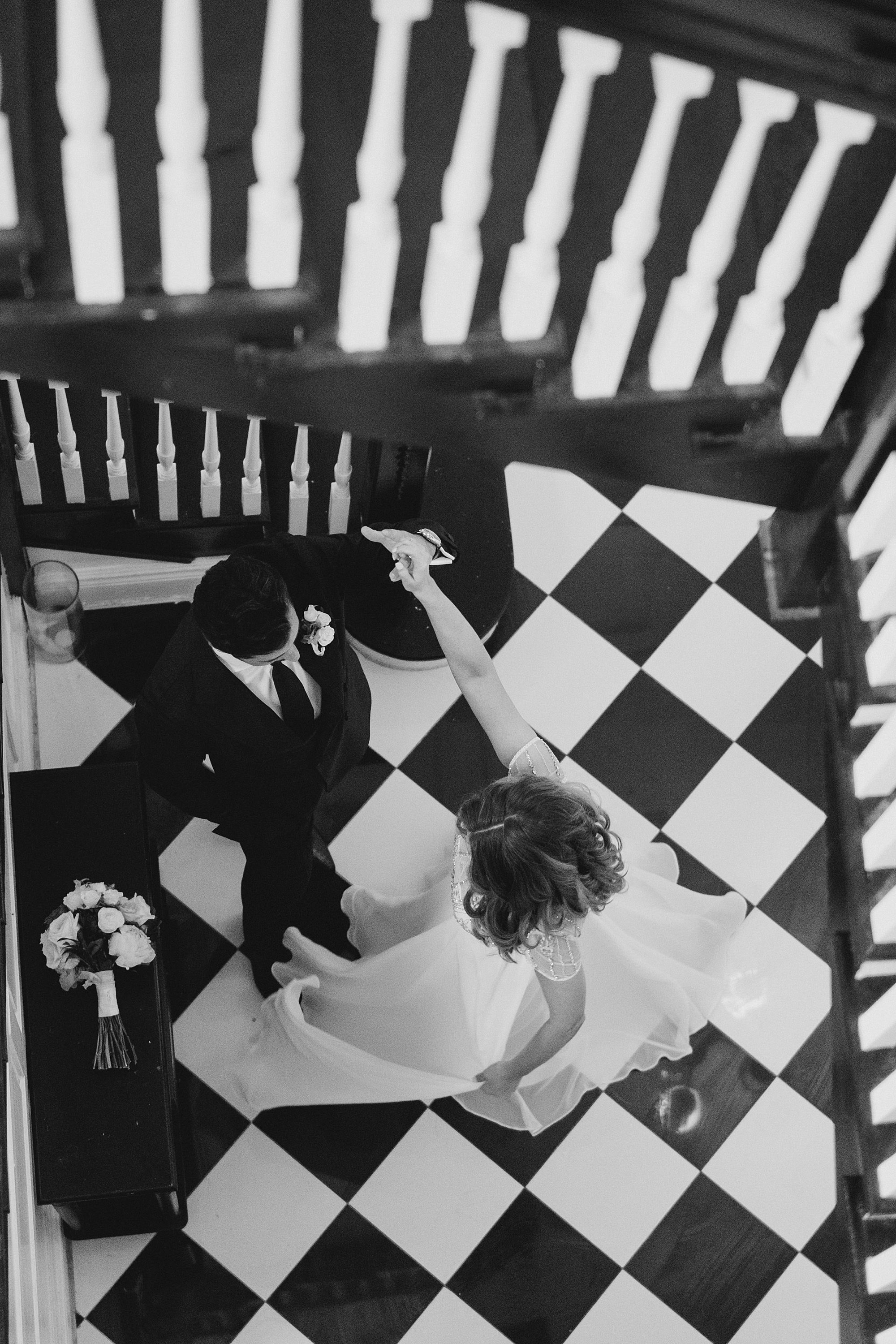 bride and groom at the bottom of staircase at Vaux Studio