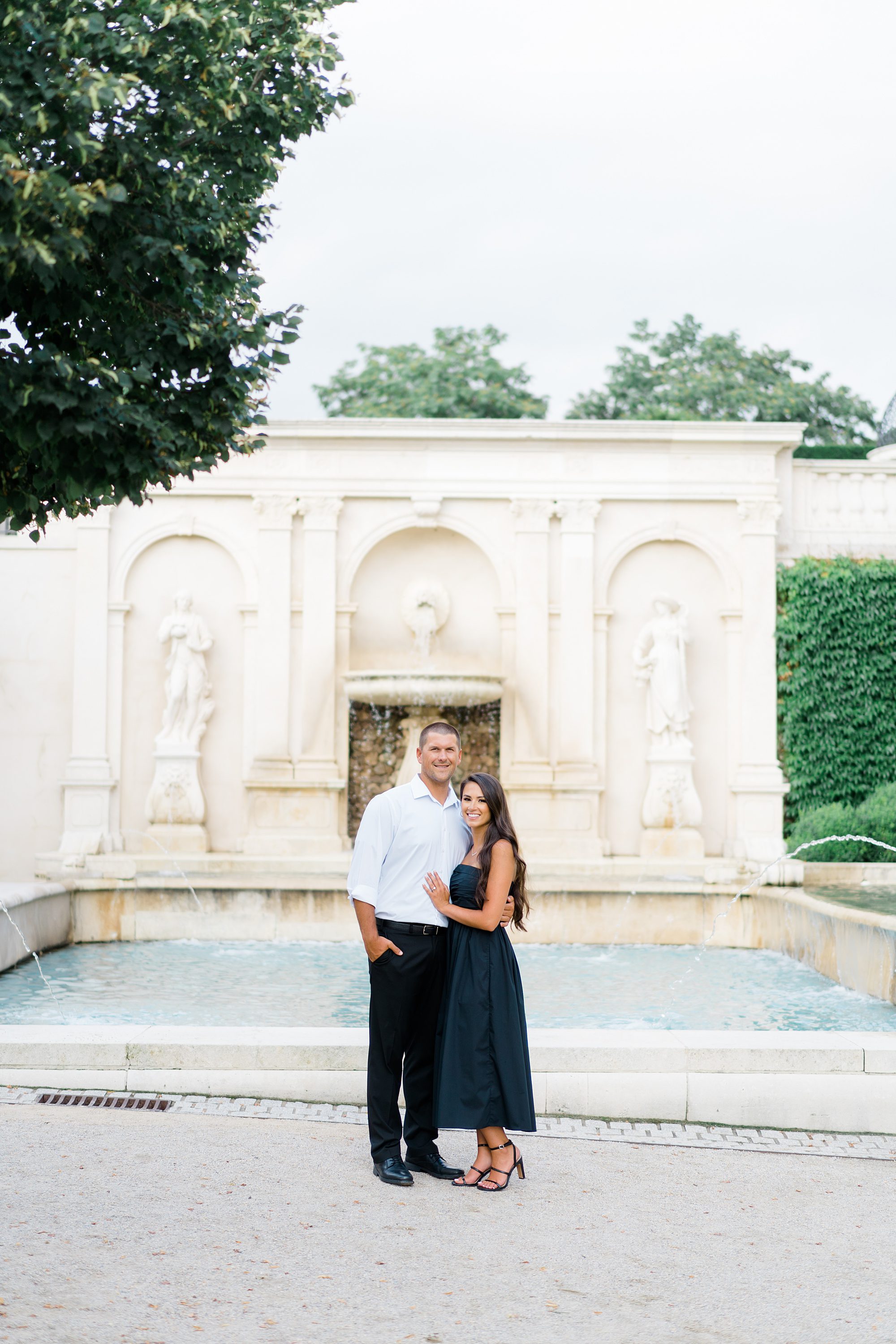 engaged couple in front of water fountain at Longwood Gardens