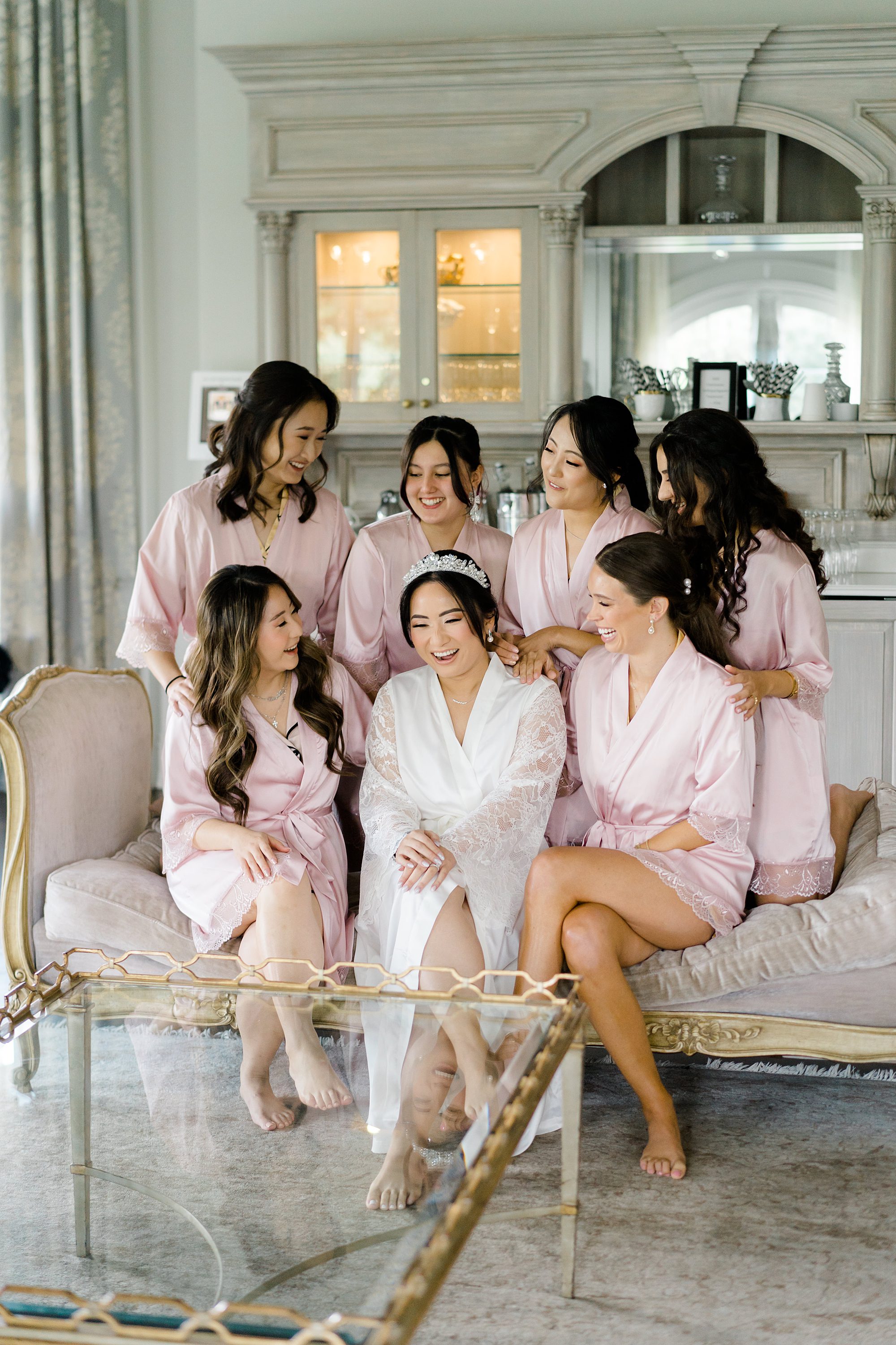 bride and bridesmaids in matching robes getting ready before Elegant Park Chateau Wedding