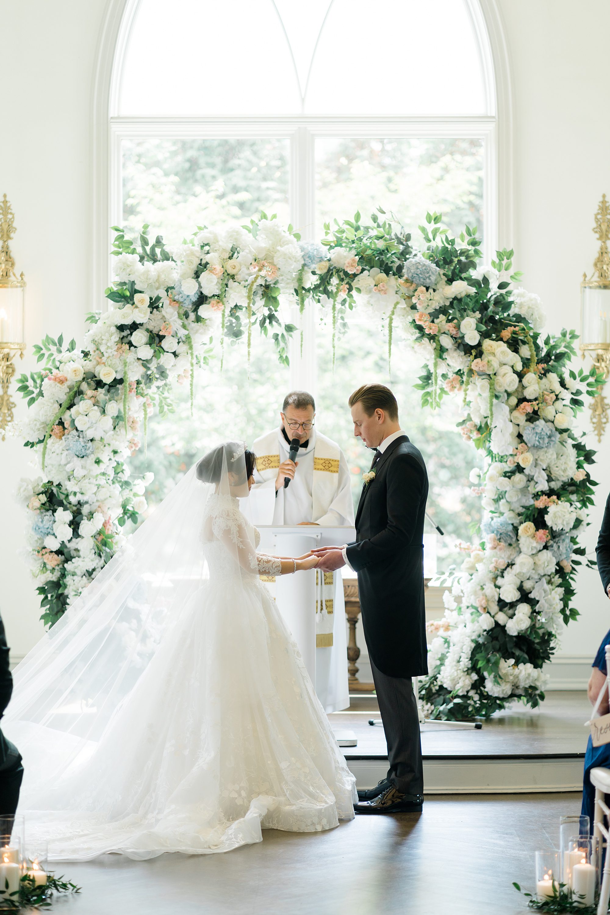 couple are married under stunning floral wedding arch