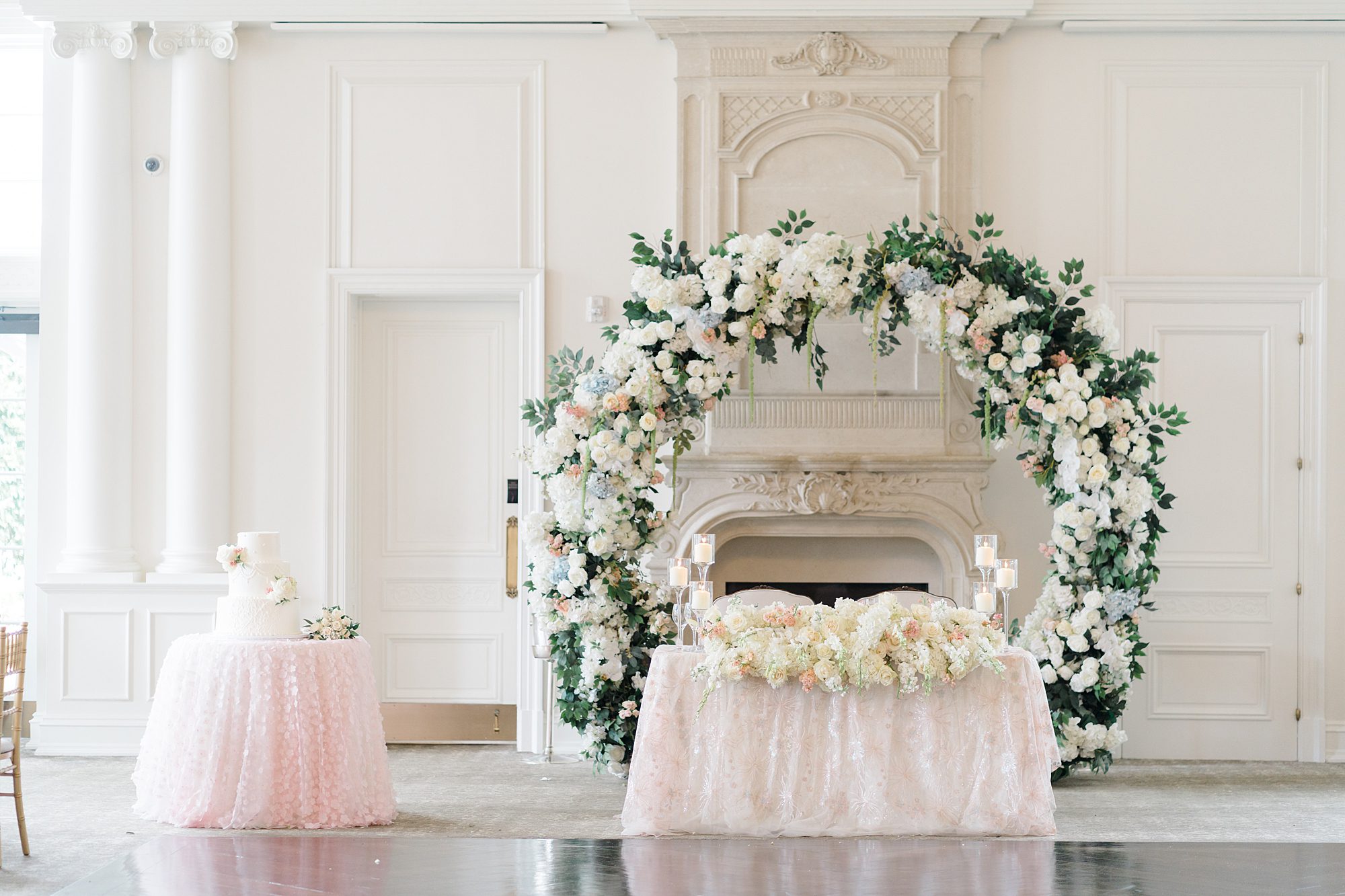Sweetheart table decorated with white and dusty pink flowers