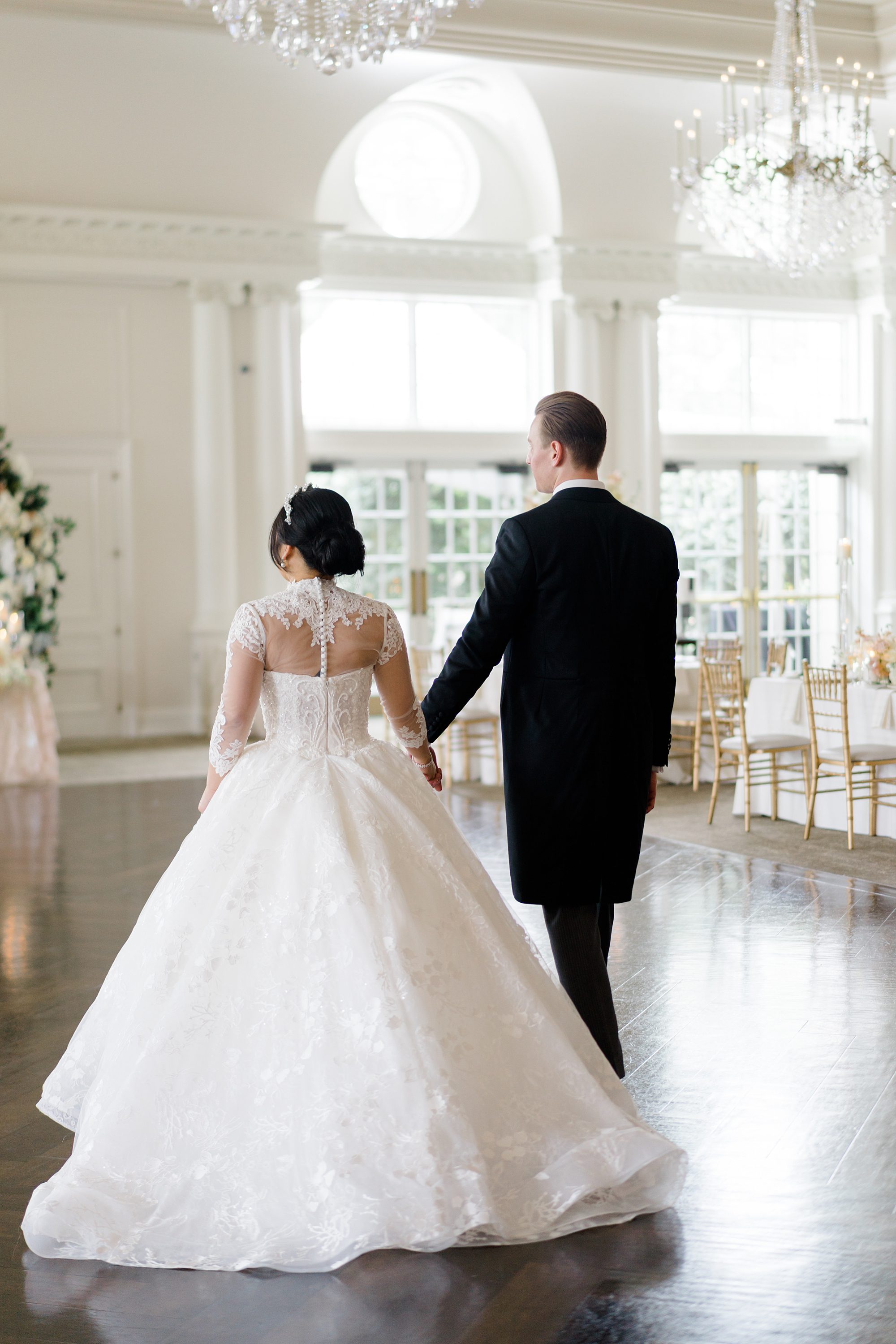 bride and groom walk on dance floor