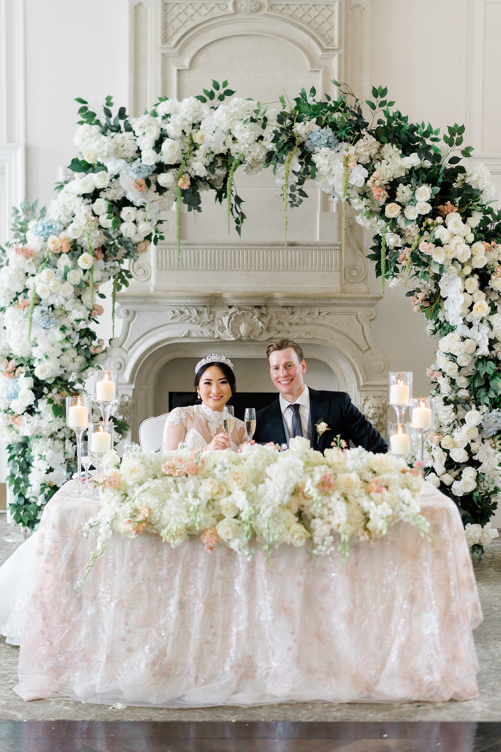 bride and groom sitting at sweetheart table at reception