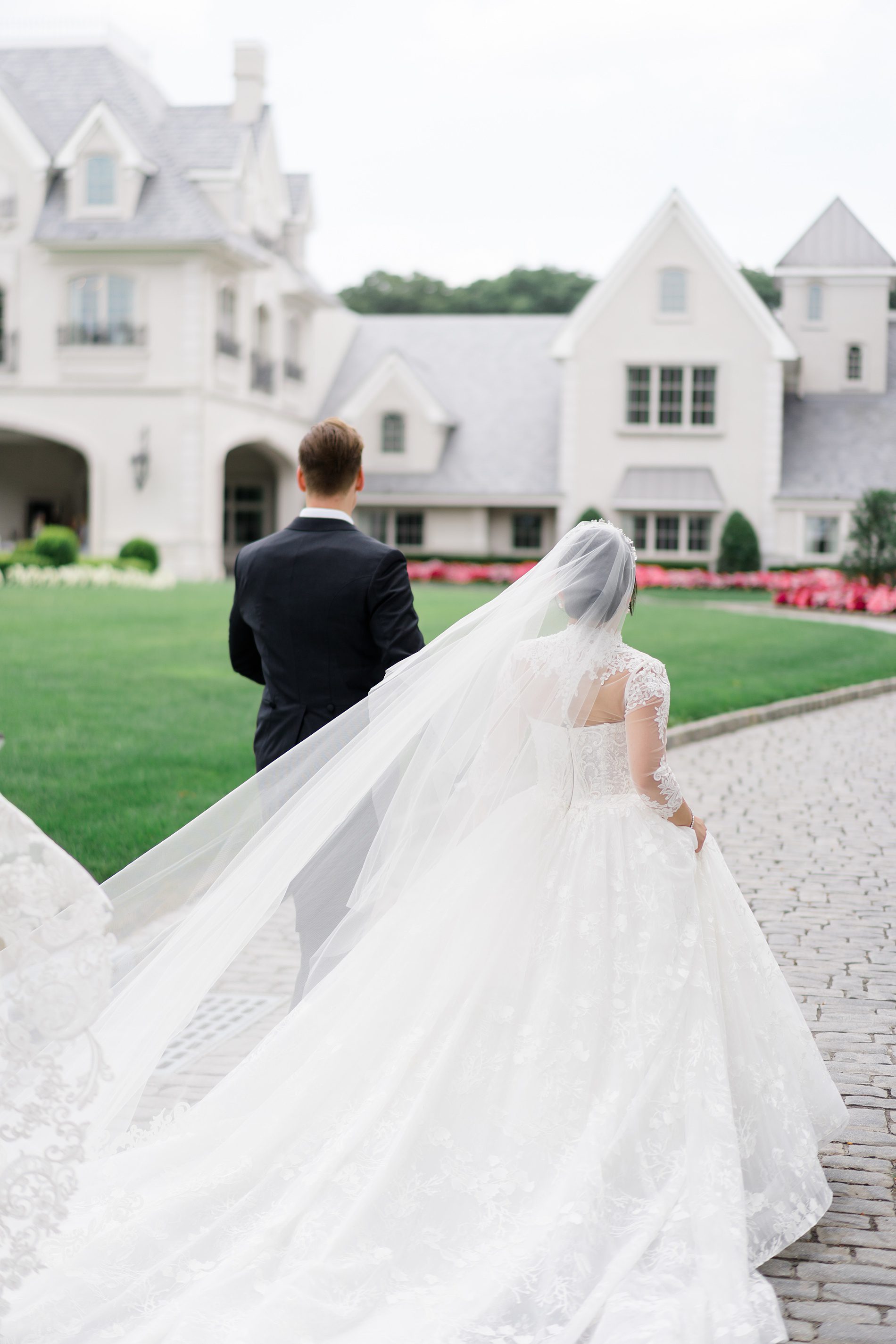 newlyweds walk about stone driveway of Park Chateau