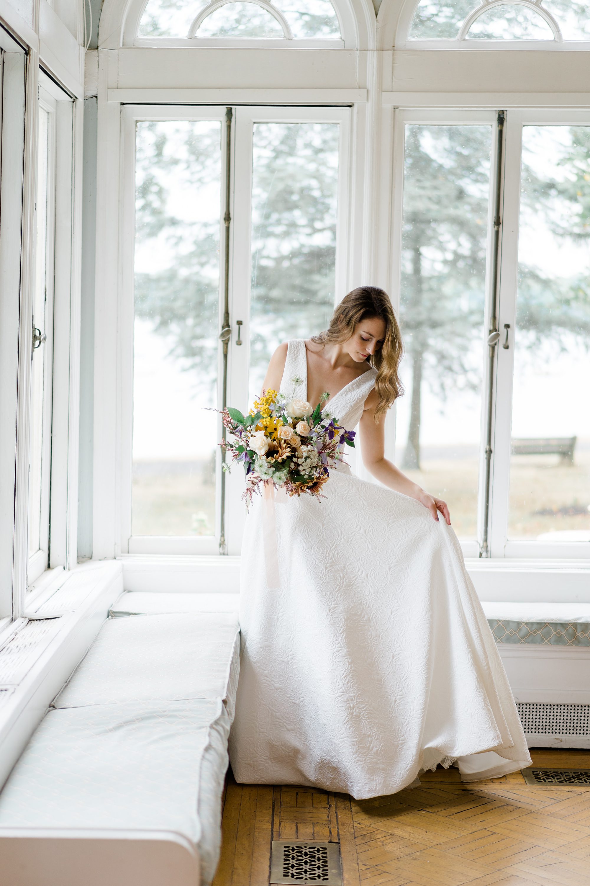 bride holding beautiful wedding bouquet by Belovely