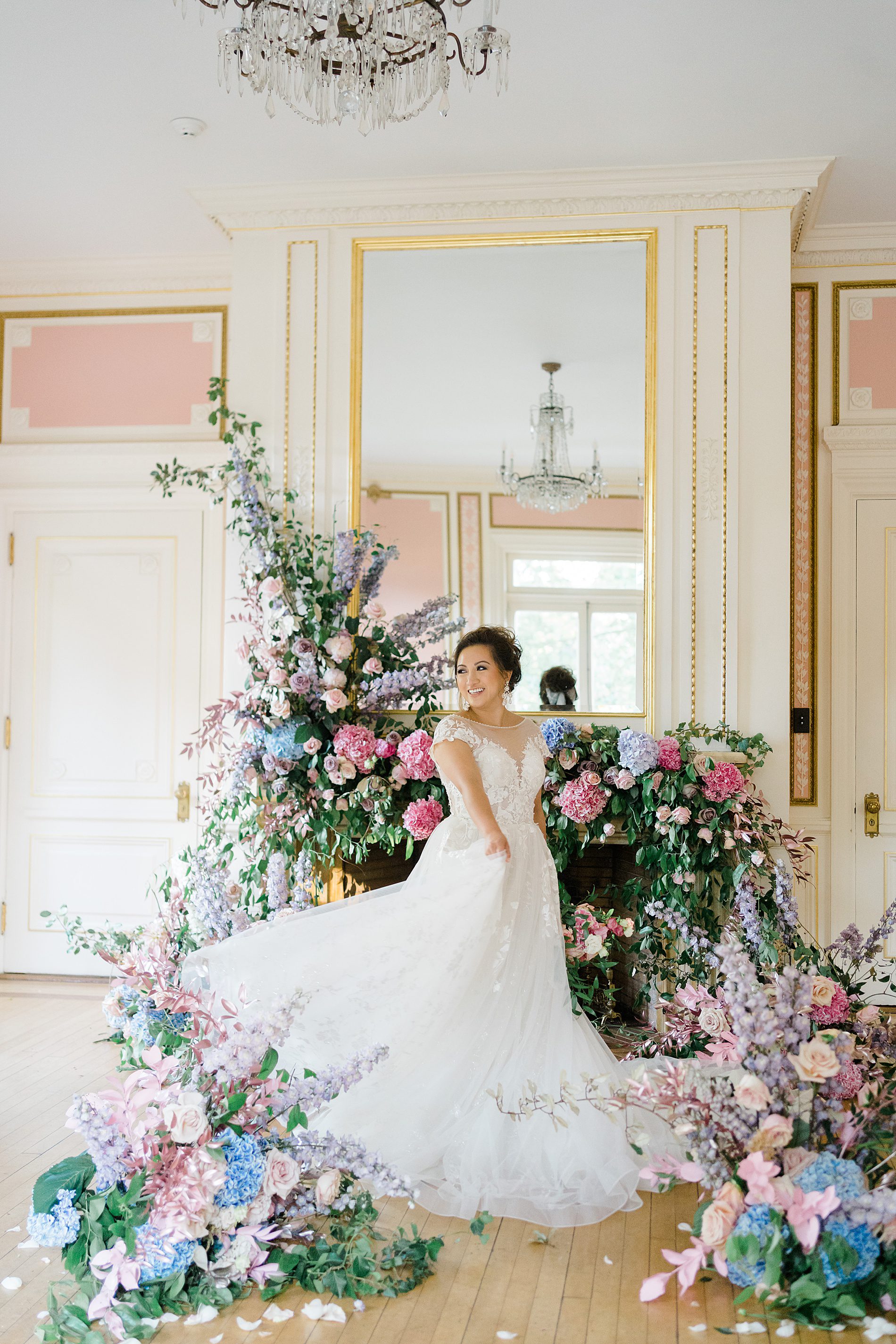 bride twirls in wedding dress surrounded by flowers