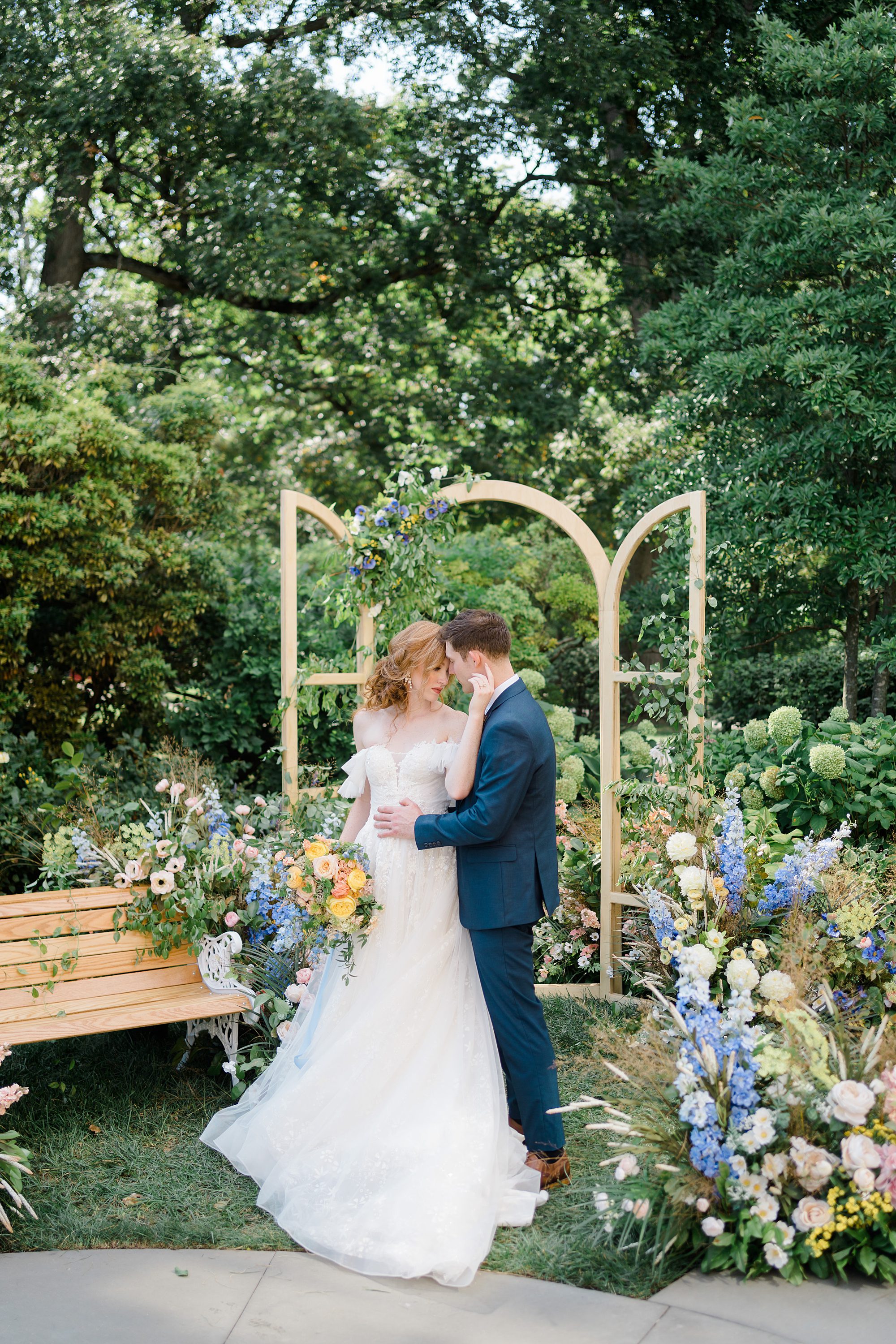 bride and groom kiss during Blue + Yellow Outdoor Garden Wedding